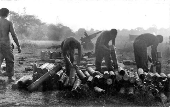 Gunners clean up after heavy fire mission in Vietnam, circa 1966-1967