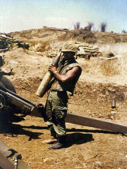 Gunner J.B.T. Kerehona holds the 100,000th New Zealand shell fired in Vietnam
