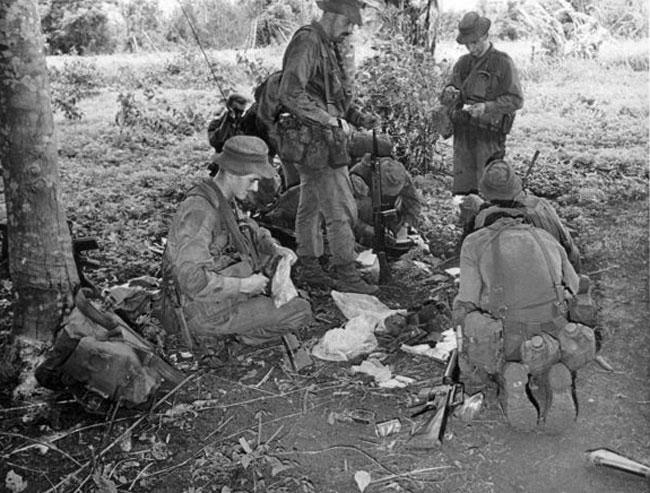 Soldiers from Victor 4 Company examine enemy documents, 1969 Soldiers from Victor 4 Company examine enemy documents, 1969