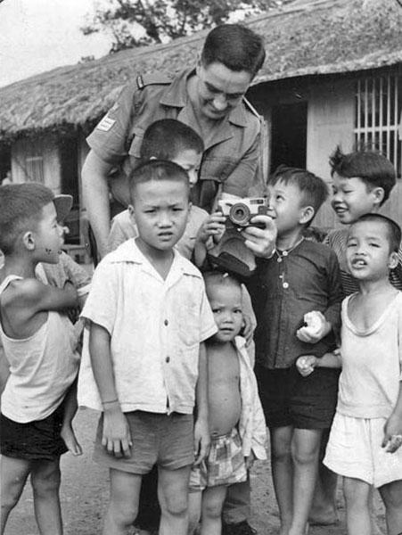 Staff Sergeant Graham Grigg with Vietnamese orphans Staff Sergeant Graham Grigg with Vietnamese orphans