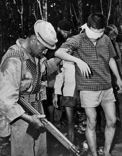 Pte T.N. (Cody) Te Koi escorts a prisoner into Victor 4 Company's base, Vietnam, 1969. Image displaying on TDB from www.vietnamwar.govt.nz