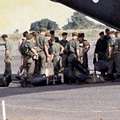 28 October 1969: After a short trip from Vung Tau the band disembarks from a RAAF Caribou transport aircraft at Luscombe field, Nui Dat. Military plane on runway with men in green uniforms standing next to it