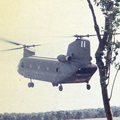 28 October 1969: A Chinook helicopter lands to transport the band to Fire Support Base Discovery, an artillery base supported by New Zealand infantry. Men in military uniforms carrying weapons watch large helicopter landing