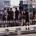 1 November 1969: Band members gather for a publicity photo on the roof of the Free World Military Headquarters in Saigon. Men in green military uniforms standing on rooftop with various coloured flags in the background
