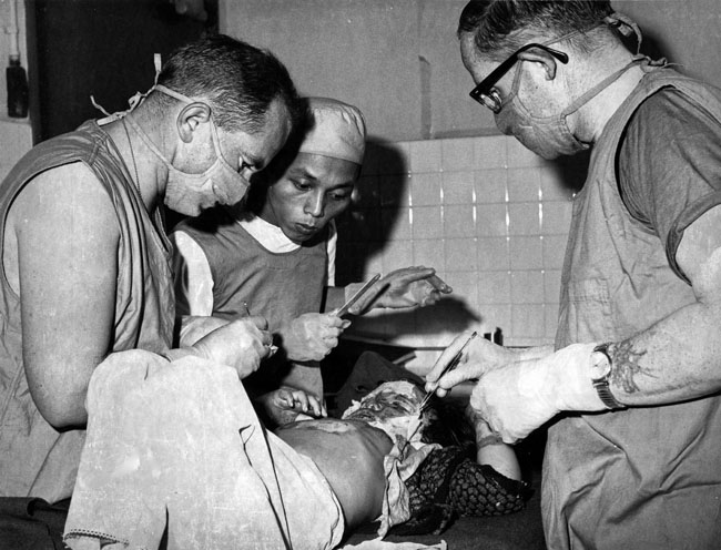 New Zealand Services Medical Team treat a Vietnamese child, Bin Dinh Province, 1970