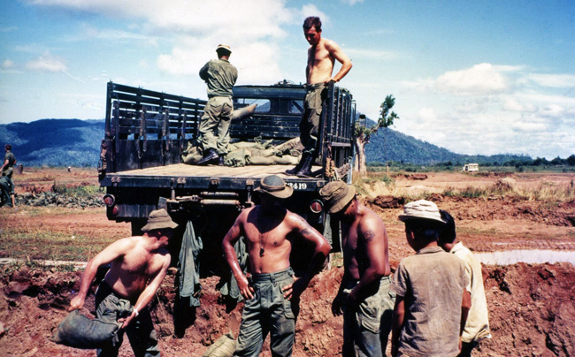 Loading sandbags on truck, circa 1968-1969