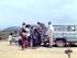 People gathered watching wire traps being loaded into the back of a Red Cross vehicle