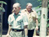 Colour photograph of two men leaving a building