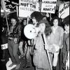 Black and white photograph of Ngā Tamatoa and Polynesian Panthers members marching with signs during an anti-war 'mobilisation' in Auckland, 14 July 1972 