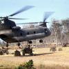 Chinook helicopter moving Howitzer artillery, circa 1968