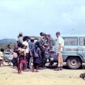 People gathered watching wire traps being loaded into the back of a Red Cross vehicle
