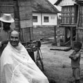 Ken Treanor receives haircut in Montagnard village, circa 1968