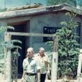 Colour photograph of two men leaving a building